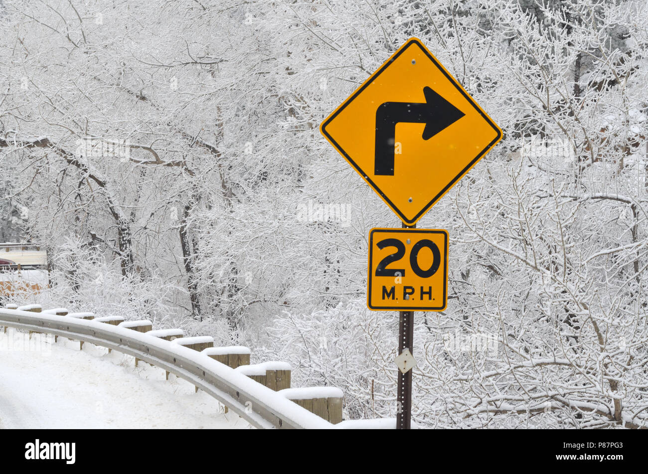Sharp right curve sign and reduced speed sign. 20 MPH Stock Photo