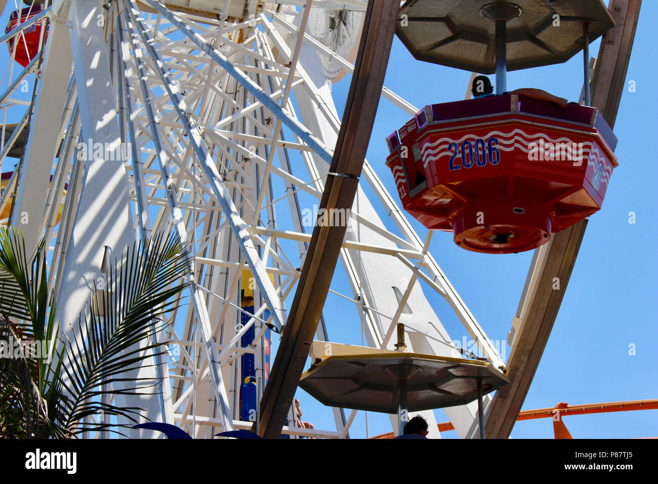 Close up view of a bright Ferris Wheel with clear blue sky background ...
