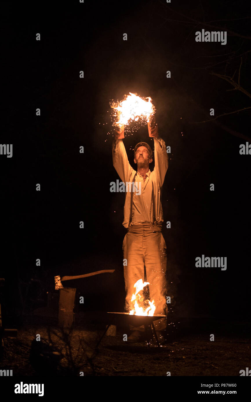 Fire aloft, Jony Easterby in his new show Tree and Wood at the Timber Festival Stock Photo