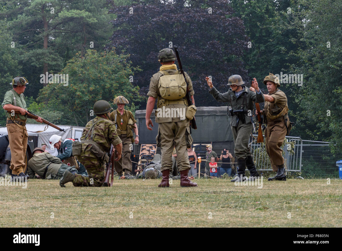 2nd world war reenactors performing as allied soldiers rounding up