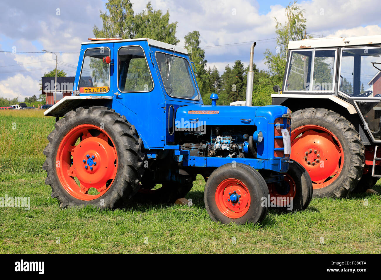 Colorful, classic Fordson Super Major tractor with cab on display on Kimito Traktorkavalkad, Tractor Cavalcade. Kimito, Finland - July 7, 2018. Stock Photo