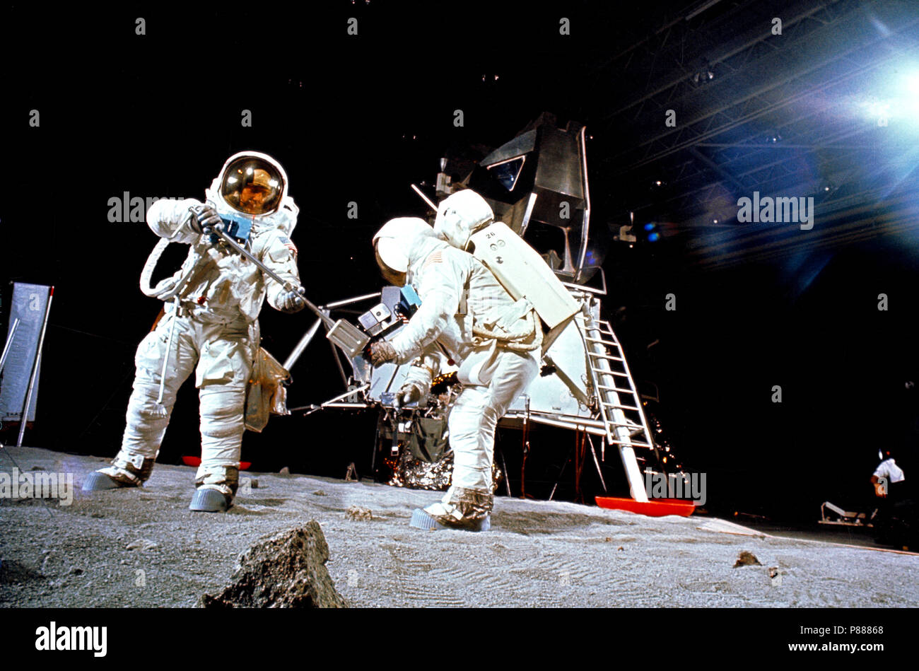 Two members of the Apollo 11 lunar landing mission participate in a simulation of deploying and using lunar tools, on the surface of the moon, during a training exercise Stock Photo