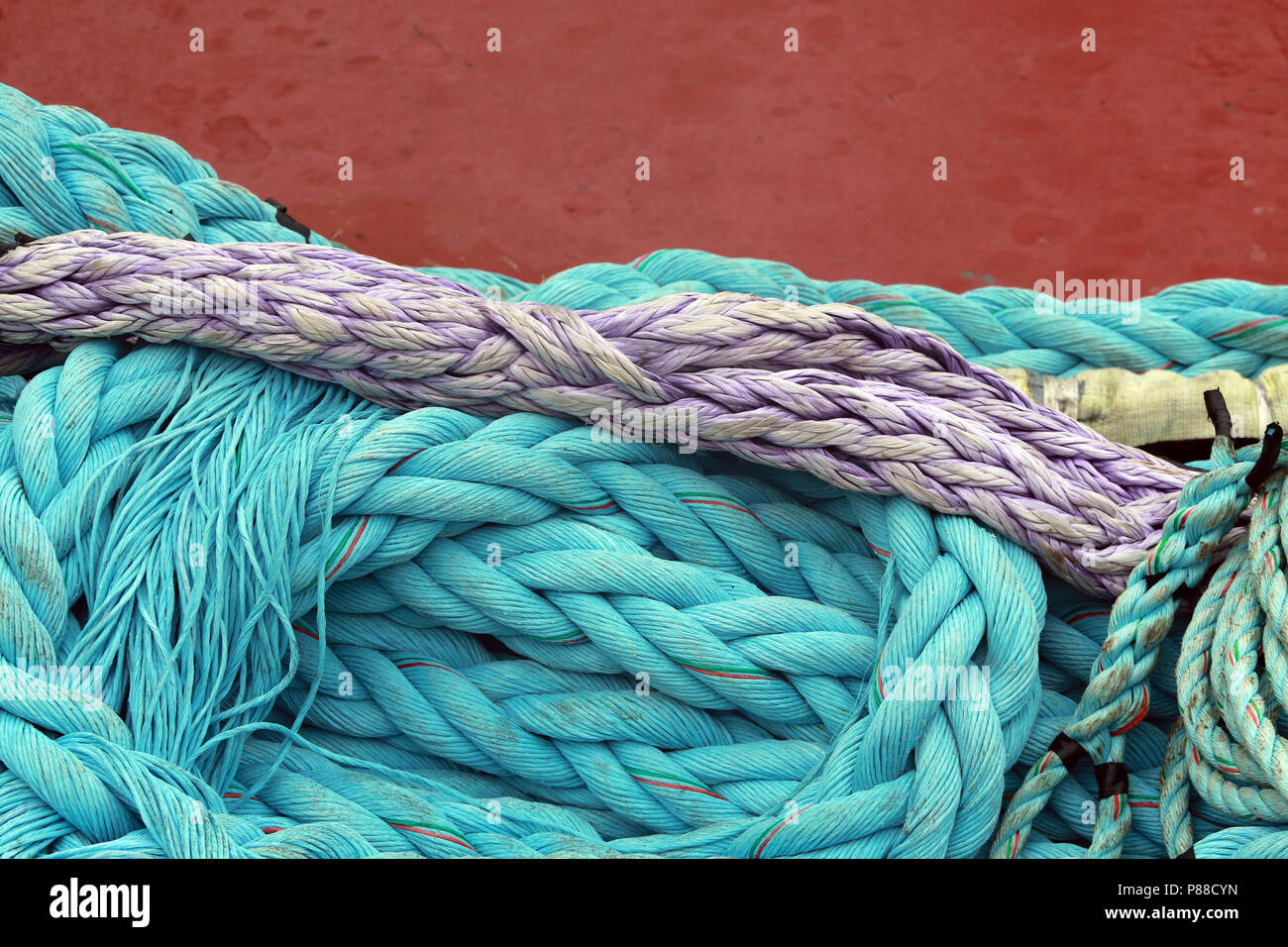 colorful purple and blue green mooring lines against res ship full Stock Photo Alamy