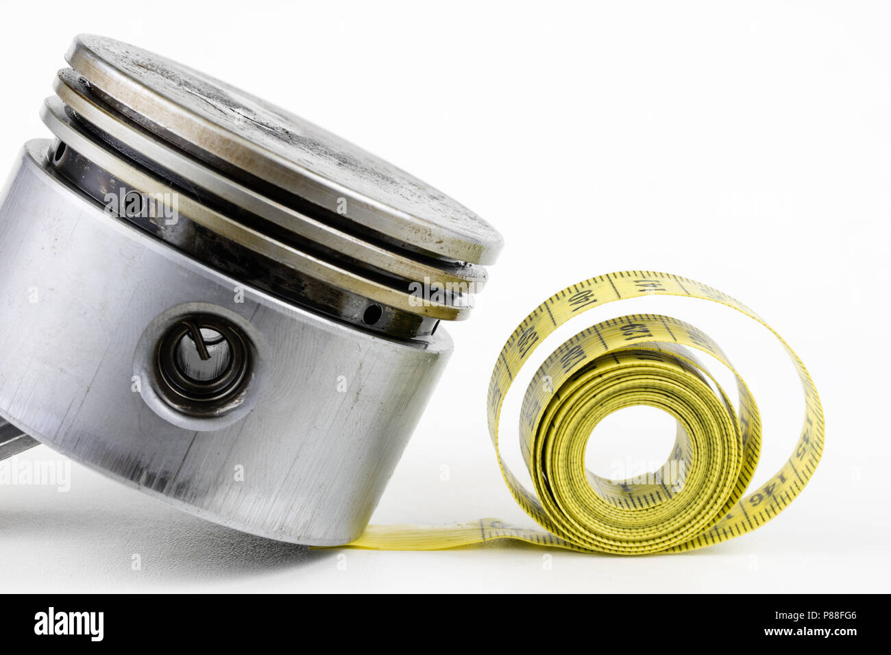 A piston from an internal combustion engine and a tailor measure on a
