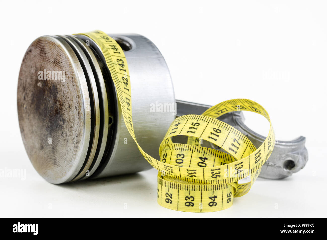 A piston from an internal combustion engine and a tailor measure on a