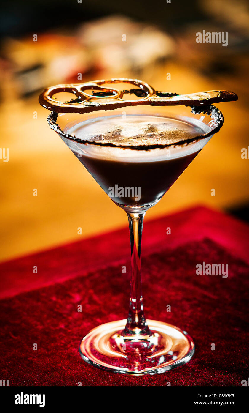 chocolate caramel cream martini mixed cocktail glass inside cozy bar