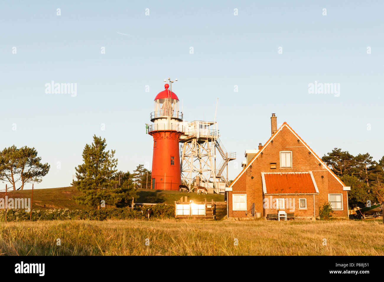 Vuurtoren en woning in de duinen; Lighthouse and house in dunes Stock Photo