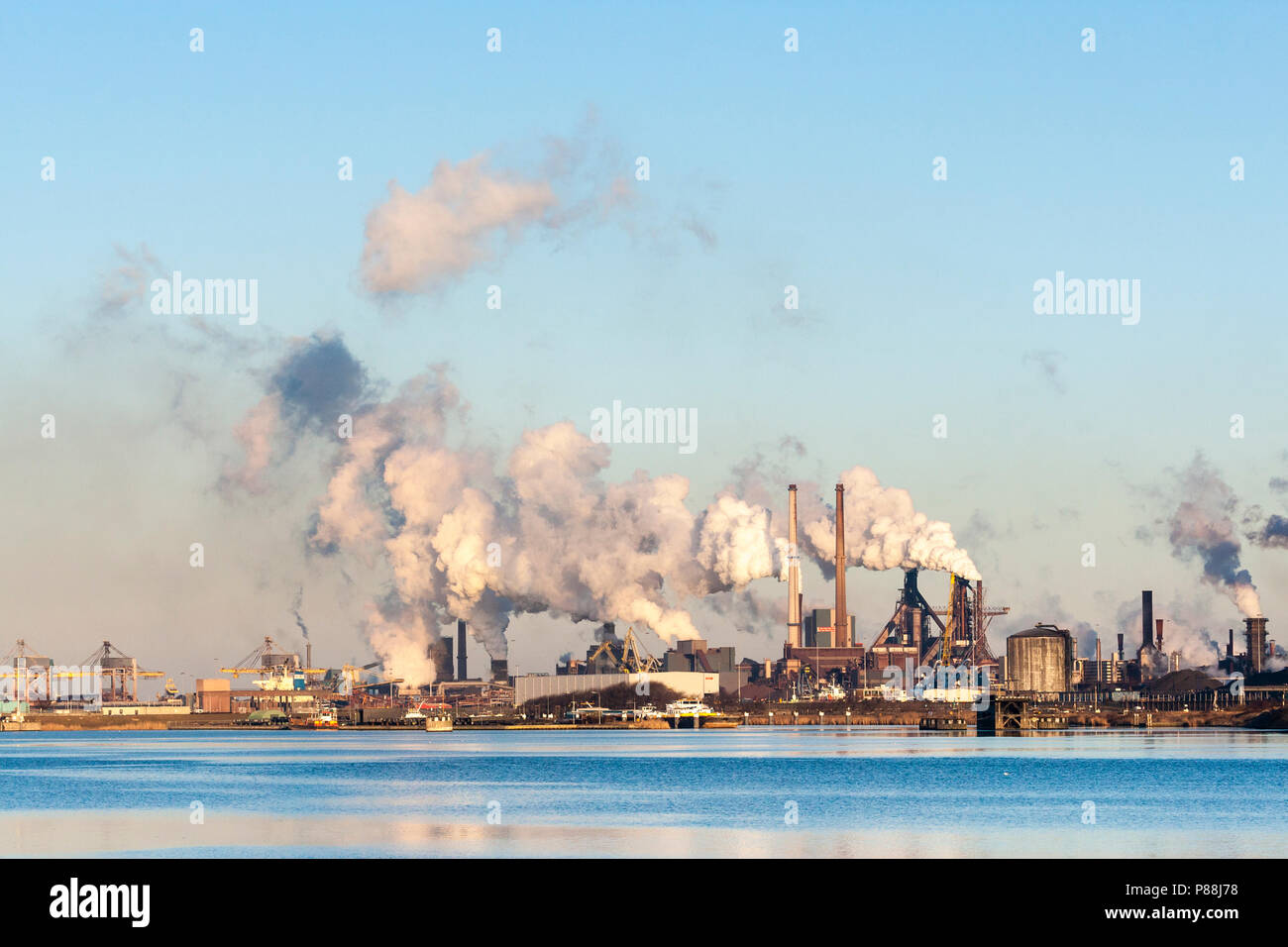 Hoogovens met rokende schoorstenen in IJmuiden; Blast furnaces with smoking chimneys at IJmuiden Stock Photo