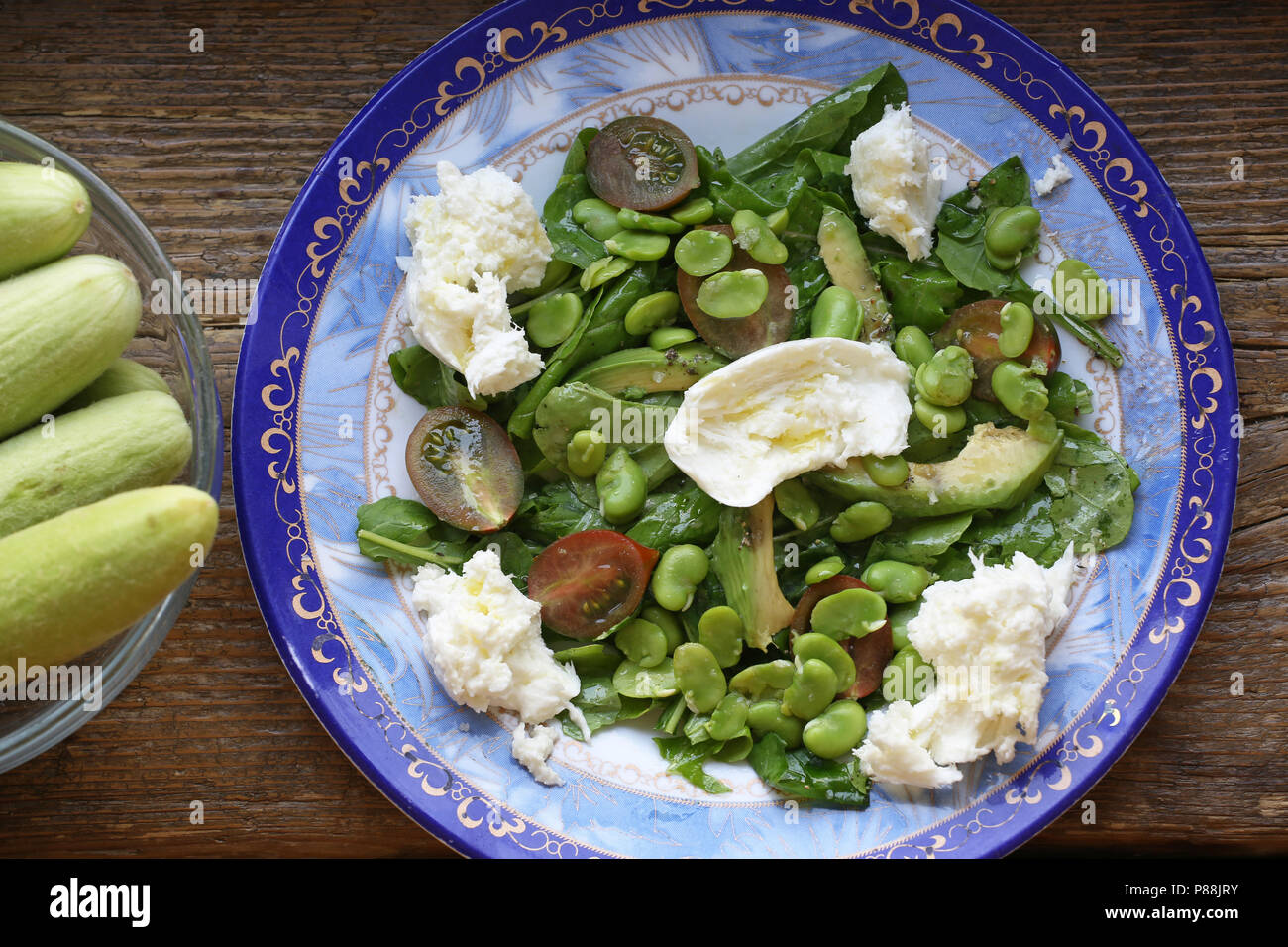 Fava bean salad with mozzarella cheese in blue ceramic bowl, Tel Aviv, Israel Stock Photo