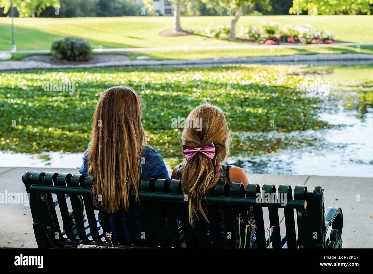 Two girls on bench lake hi-res stock photography and images - Alamy