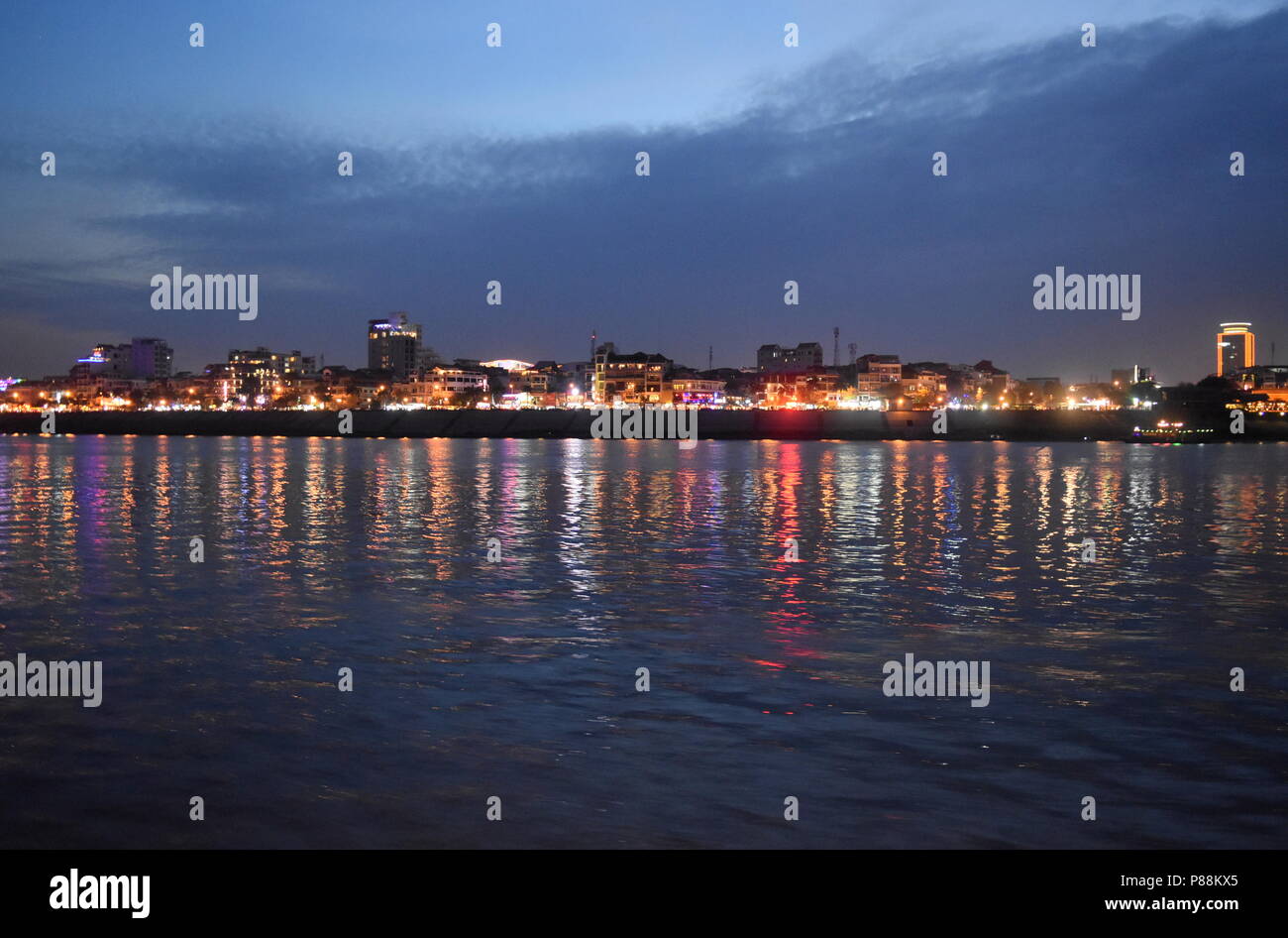 Cambodia capital Phnom Penh night skyline lights reflected along Mekong River Stock Photo