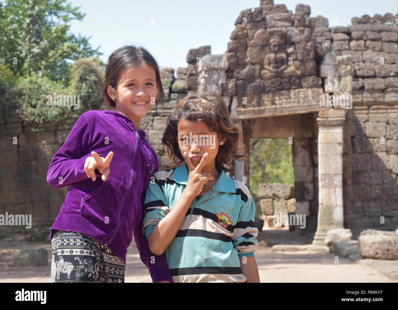 Two friendly Cambodian girls presenting Ta Prohm ancient temple to tourists  in perfect English near Tonle Bati lake Stock Photo - Alamy