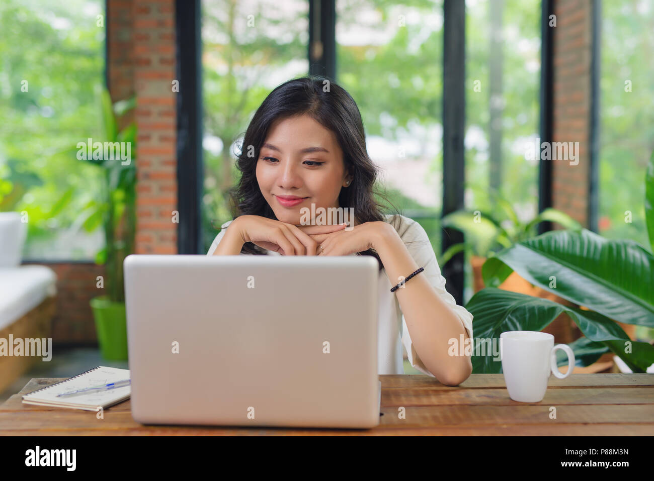 Happy Young Beautiful Woman Using Laptop, Indoors Stock Photo - Alamy