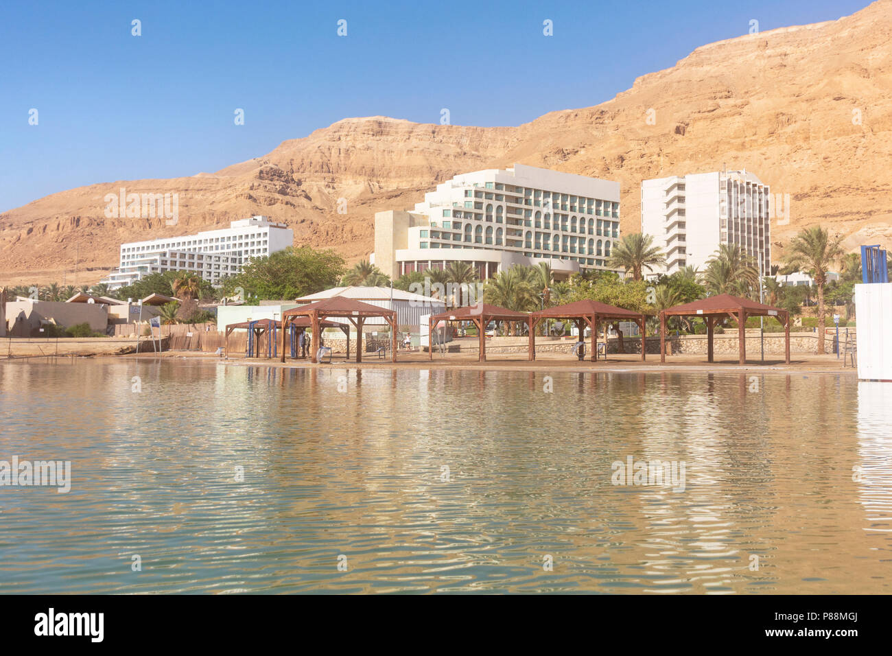 the beach and hotels on the dead sea at ein bokek in Israel with desert mountains in the background Stock Photo