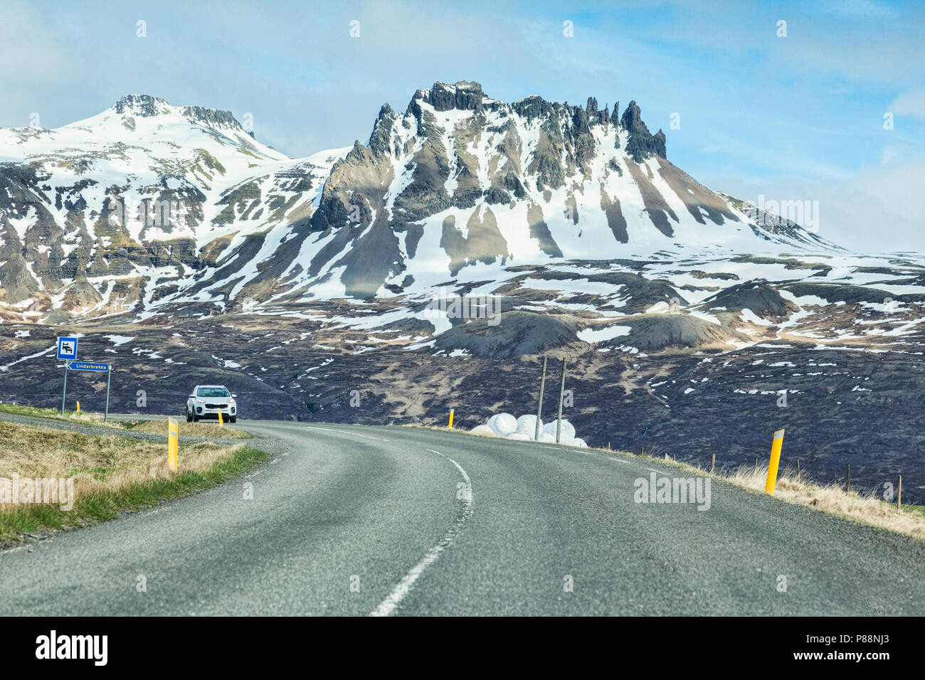 28 April 2018: South Iceland - Through the windscreen shot of the Iceland Ring Road in South Island, driving through snowy mountain scenery. Probably  Stock Photo