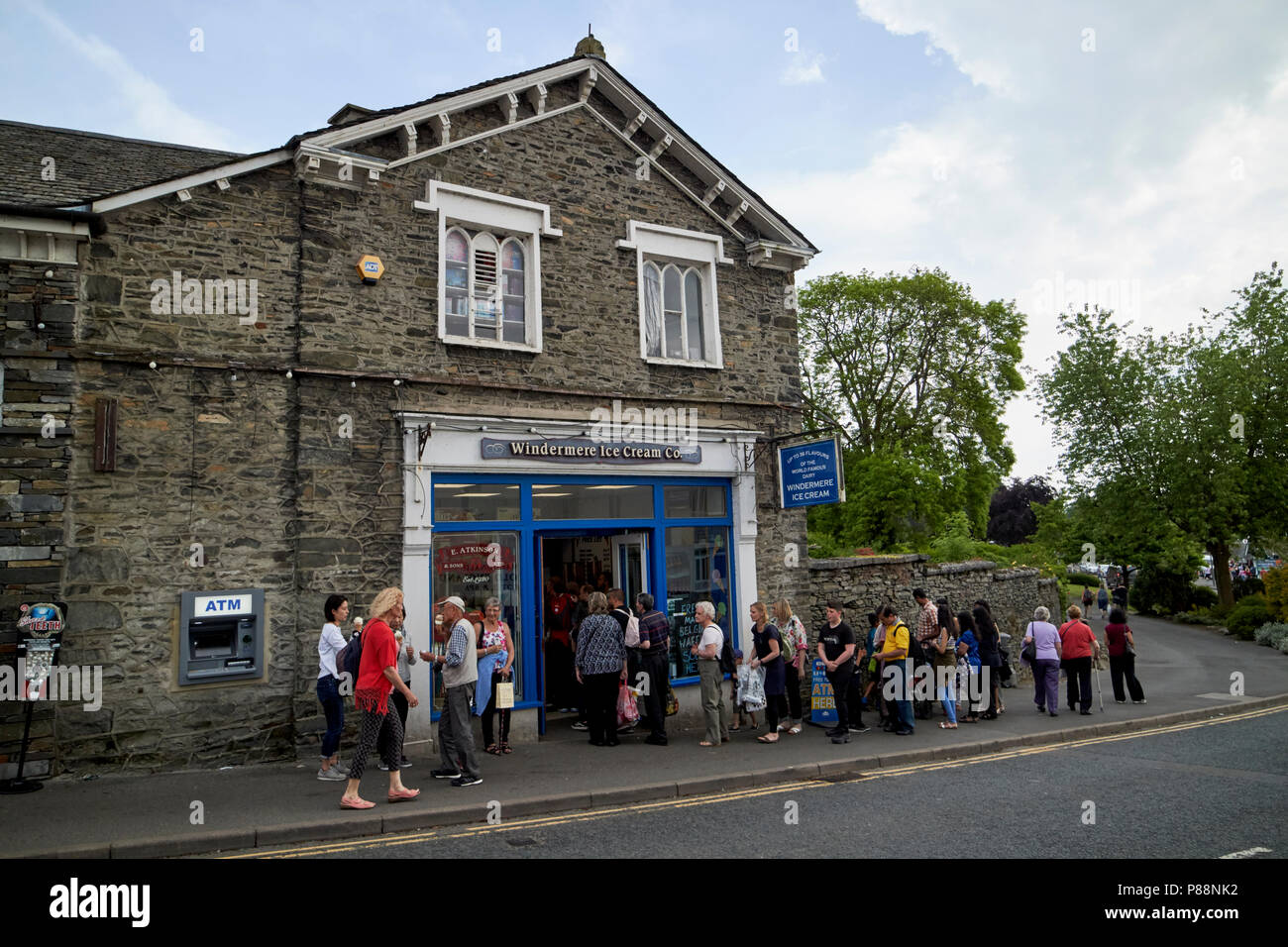 long queue of people outside windermere ice cream co shop in bowness on windermere lake district