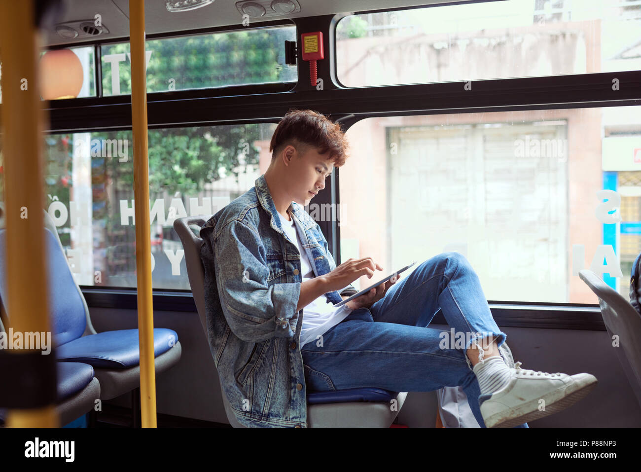 Transport. People in the bus. He reading book in transport. Stock Photo