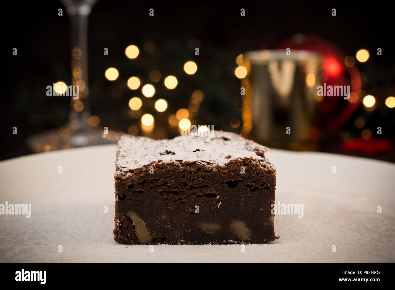 Chocolate Brownie With Icing Sugar Served In A White Plate And