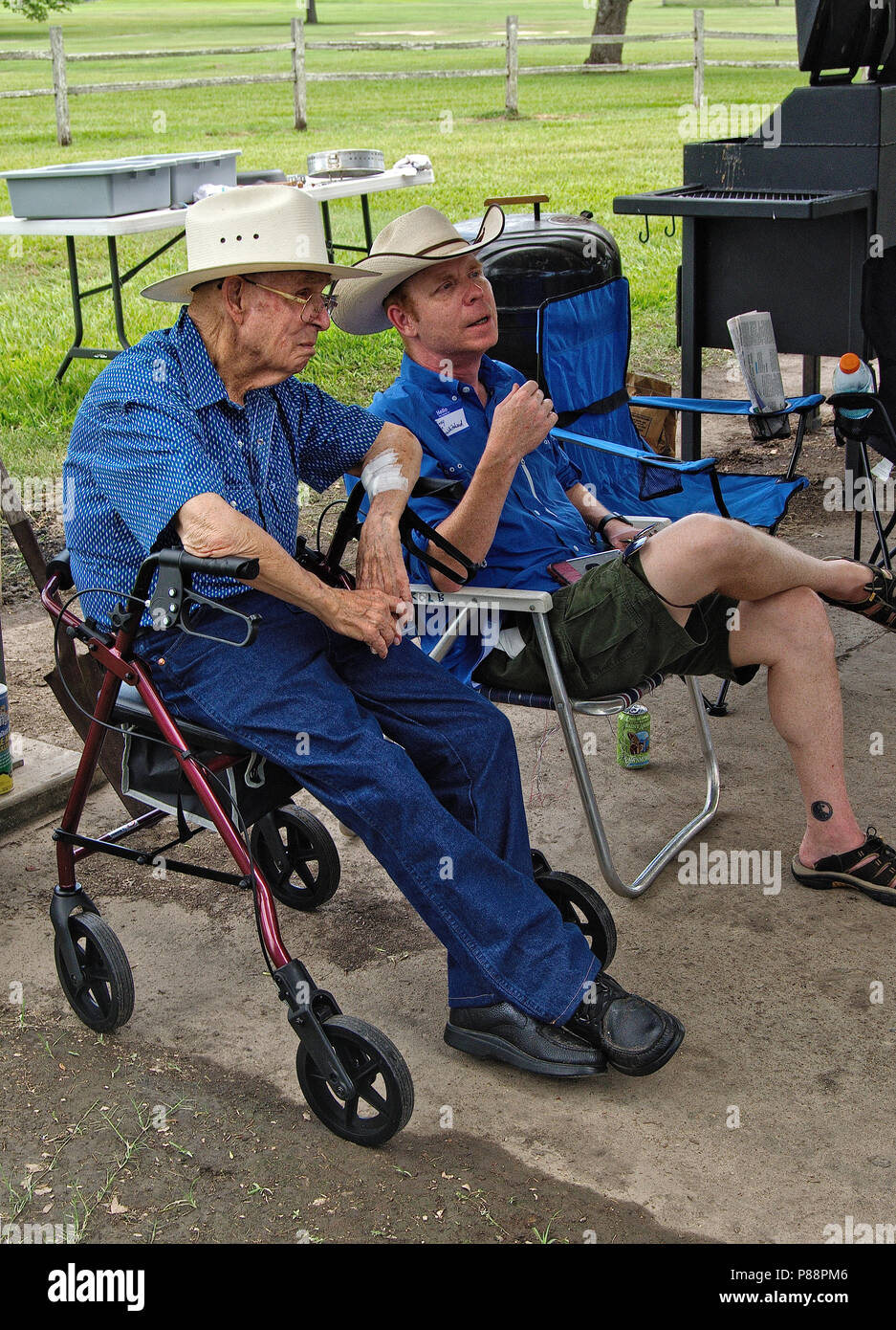 Elderly man sitting on walker seat for handicap talking to young man Stock  Photo - Alamy