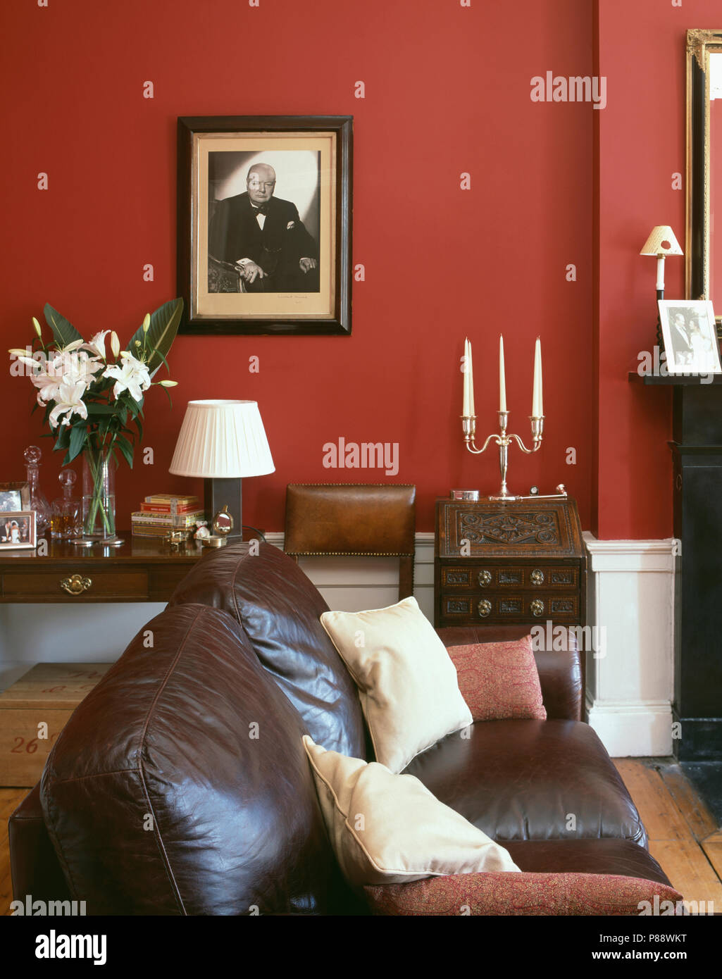 Leather sofa in traditional red living room Stock Photo - Alamy