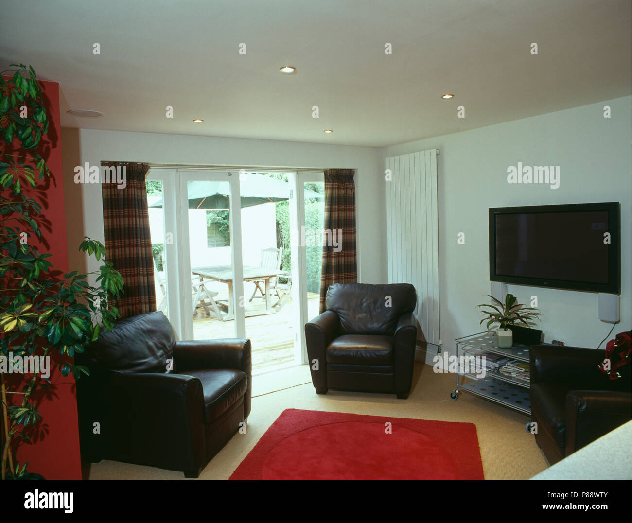 Black Leather Armchairs And Red Rug In Modern White Living