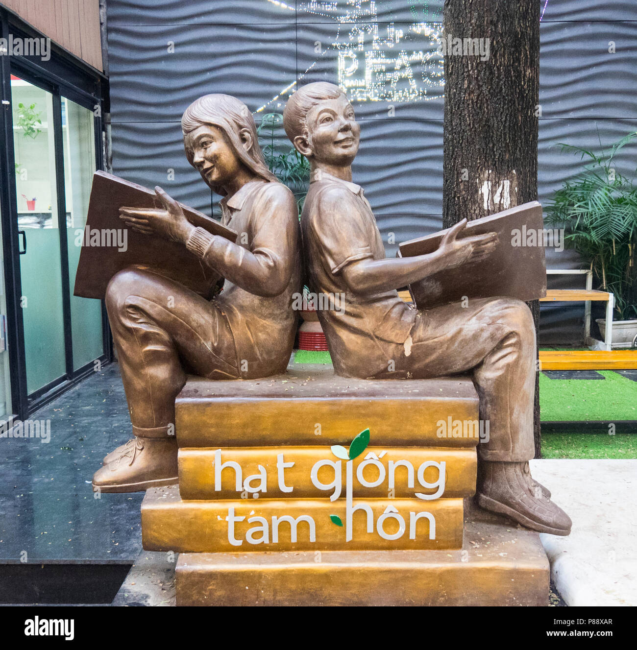 Bronze statues of a boy and girl reading books located in Book Street, Ho Chi Minh City, Vietnam