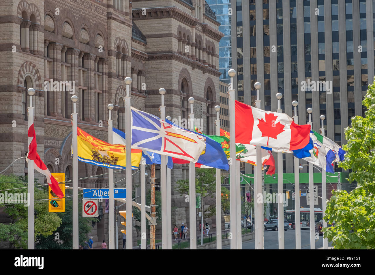 Canadian federal, provincial and territorial flags flutter in the breeze outside of City hall in Toronto Ontario Canada. Stock Photo