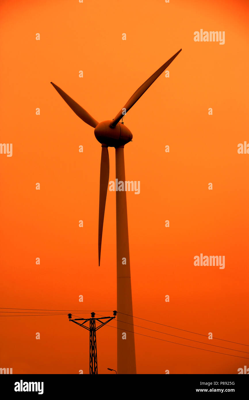 wind turbine over sunset sky Stock Photo - Alamy