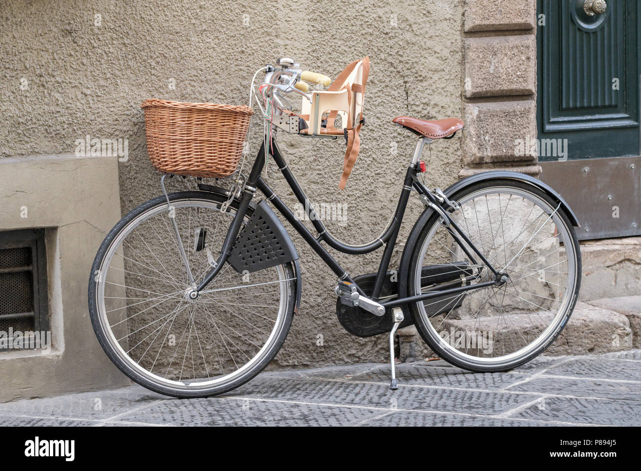 Bicycle with basket and childs seat, old city street in Lucca, Tuscany, Italy, Europe, Stock Photo