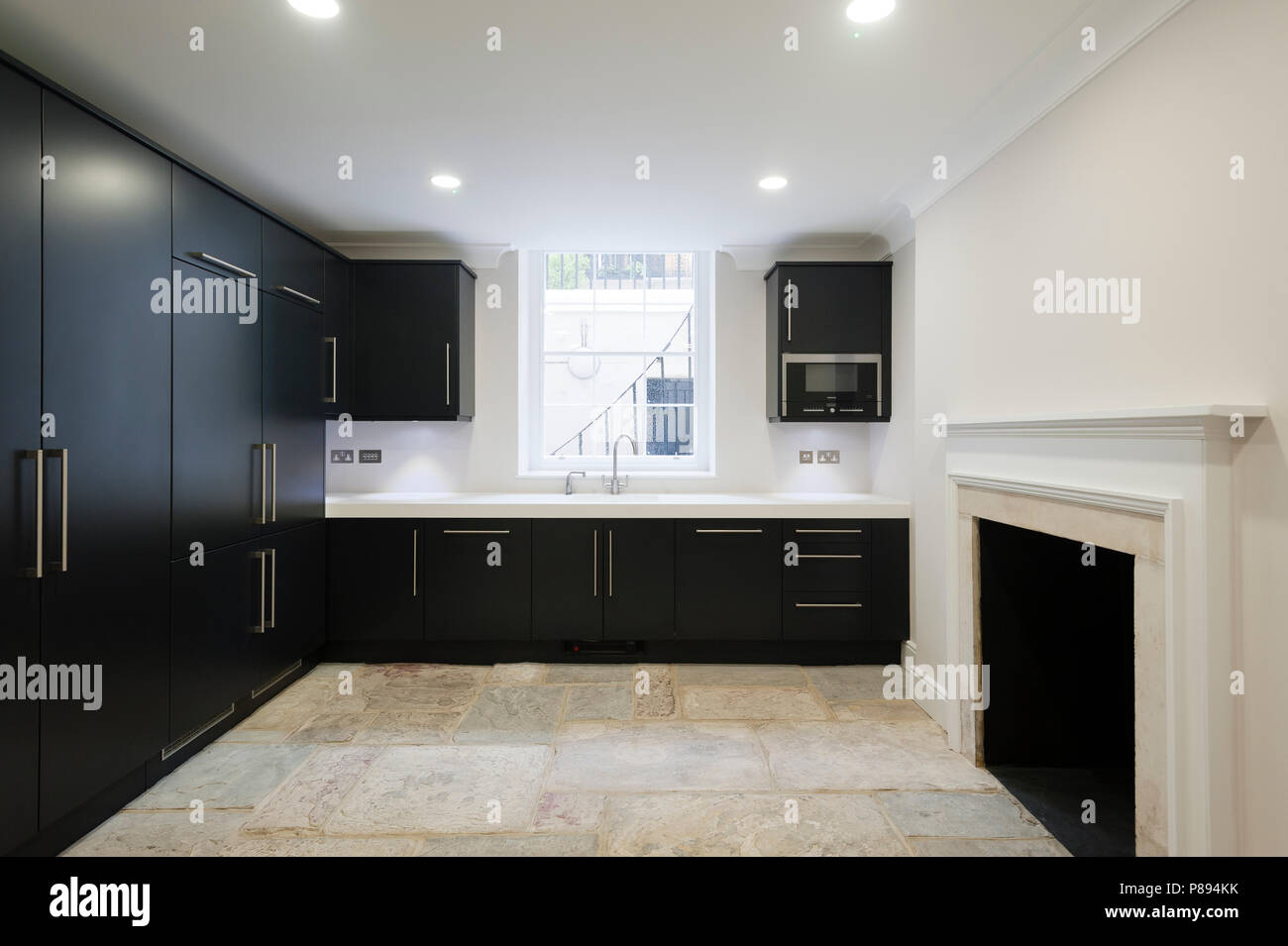 Empty modern kitchen with stone flooring Stock Photo