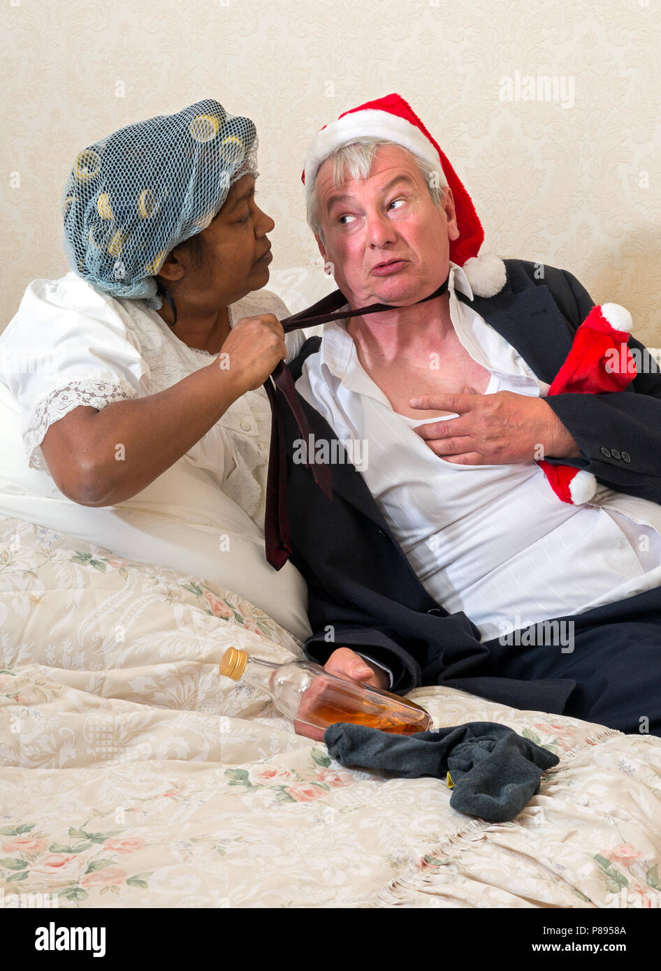 Guilty drunk husband being yelled at by his furious wife Stock Photo