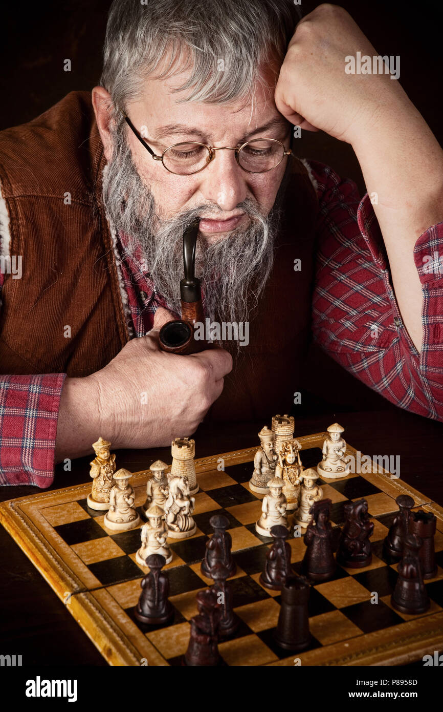 Senior man thinking about his next move in a game of chess Stock Photo by  dmytros9