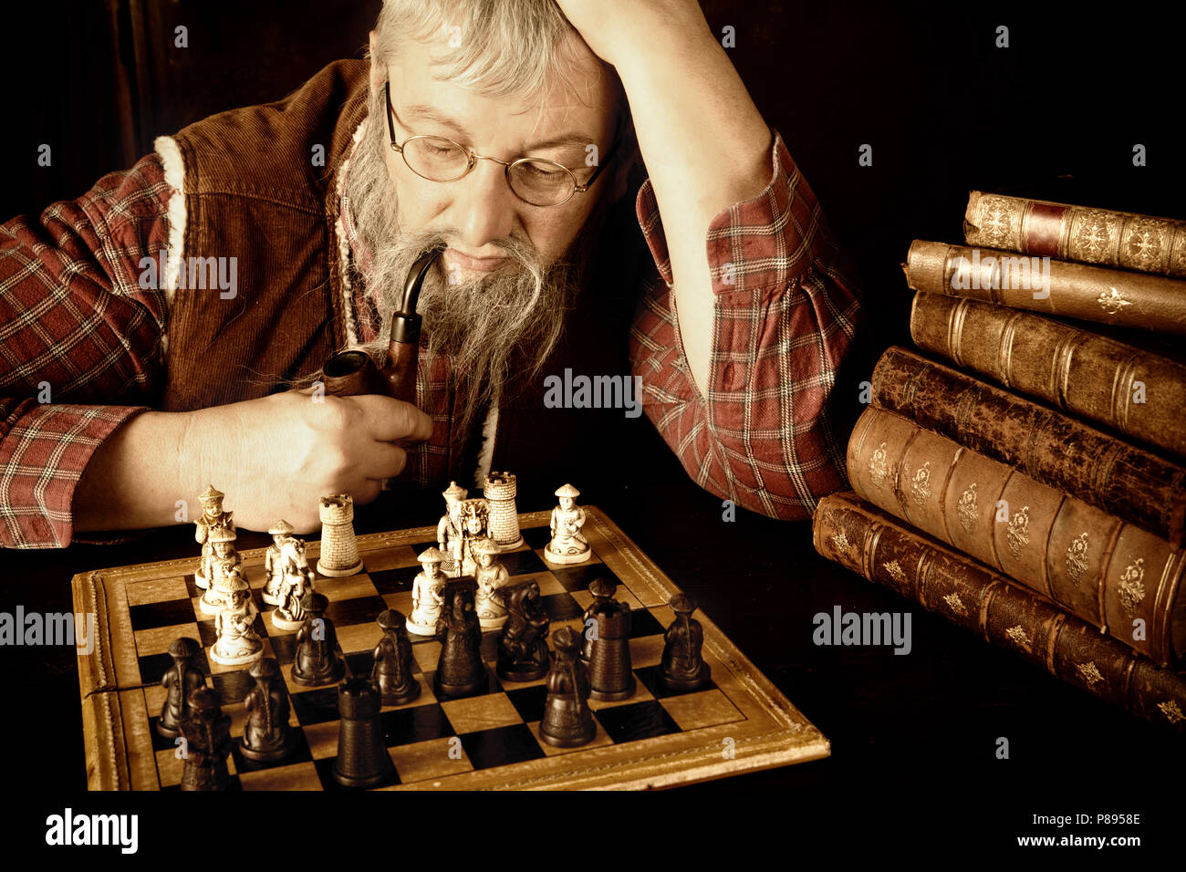 Senior man thinking about his next move in a game of chess Stock Photo by  dmytros9