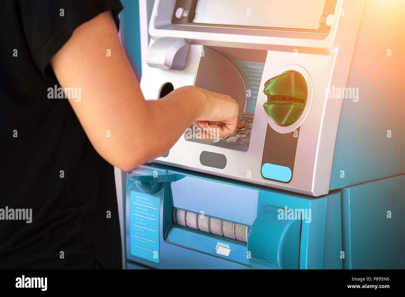 pressing password number on ATM machine - Online banking business concept. Stock Photo