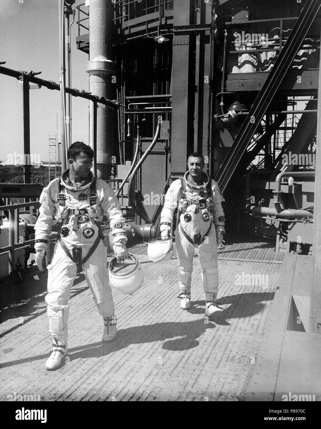 Astronauts John W. Young (left), pilot, and Virgil I. Grissom, command pilot, for the Gemini-Titan 3 flight, are shown leaving the launch pad after simulations in the Gemini-3 spacecraft. Stock Photo