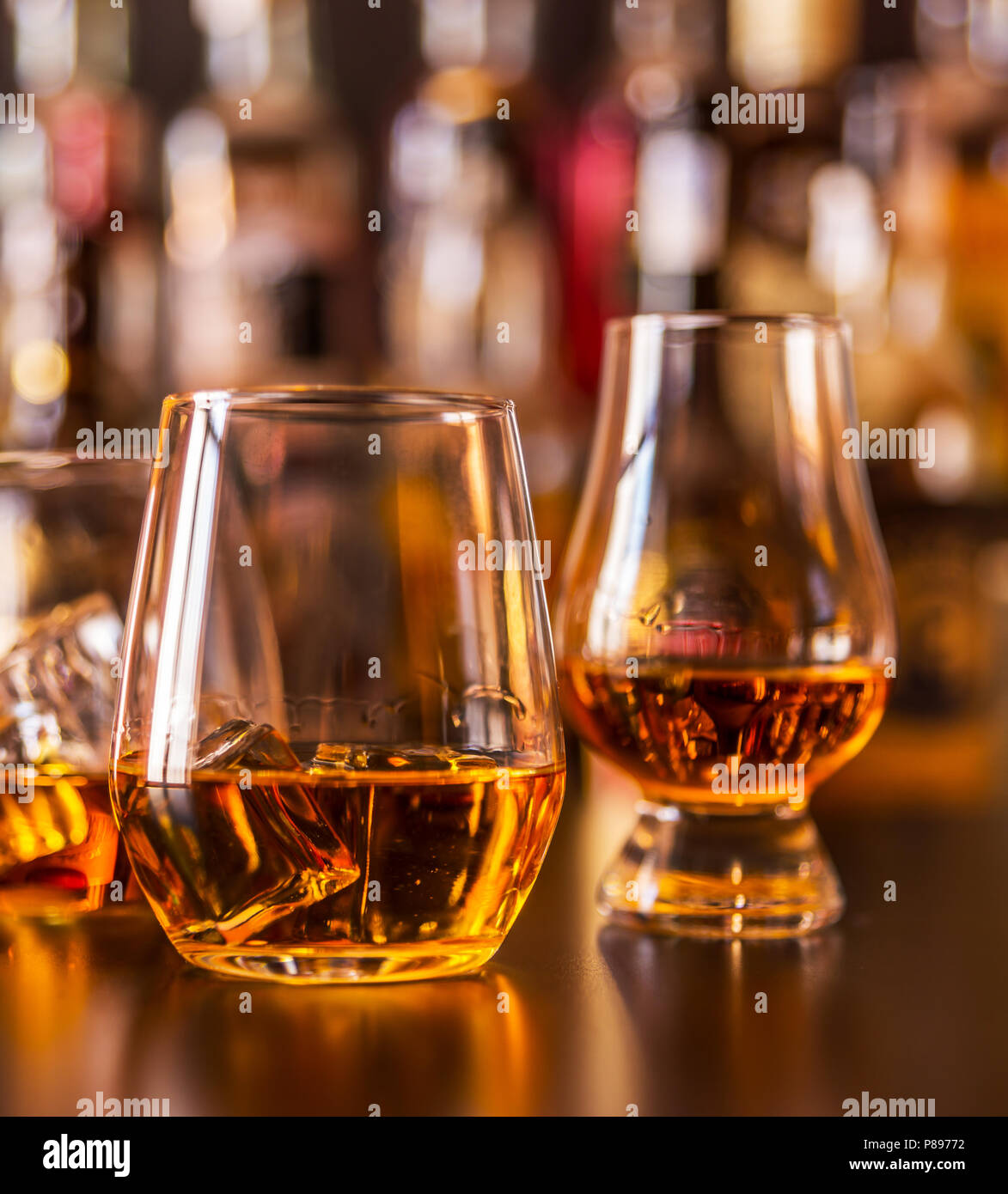 Scottish whisky in a glass with ice cubes, golden color whiskey