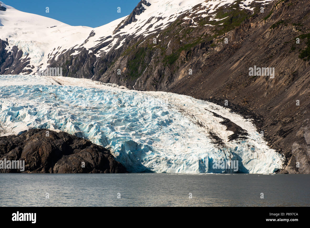 Portage Glacier as it meets Portage Lake. Stock Photo