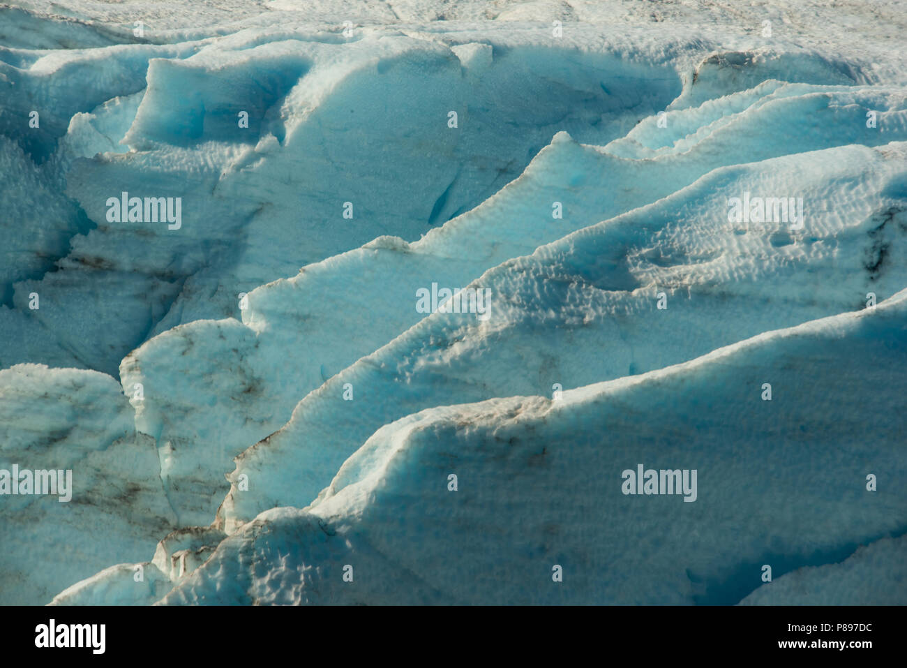 Crevasses in Portage Glacier showing the deep blue of compact ice. Stock Photo
