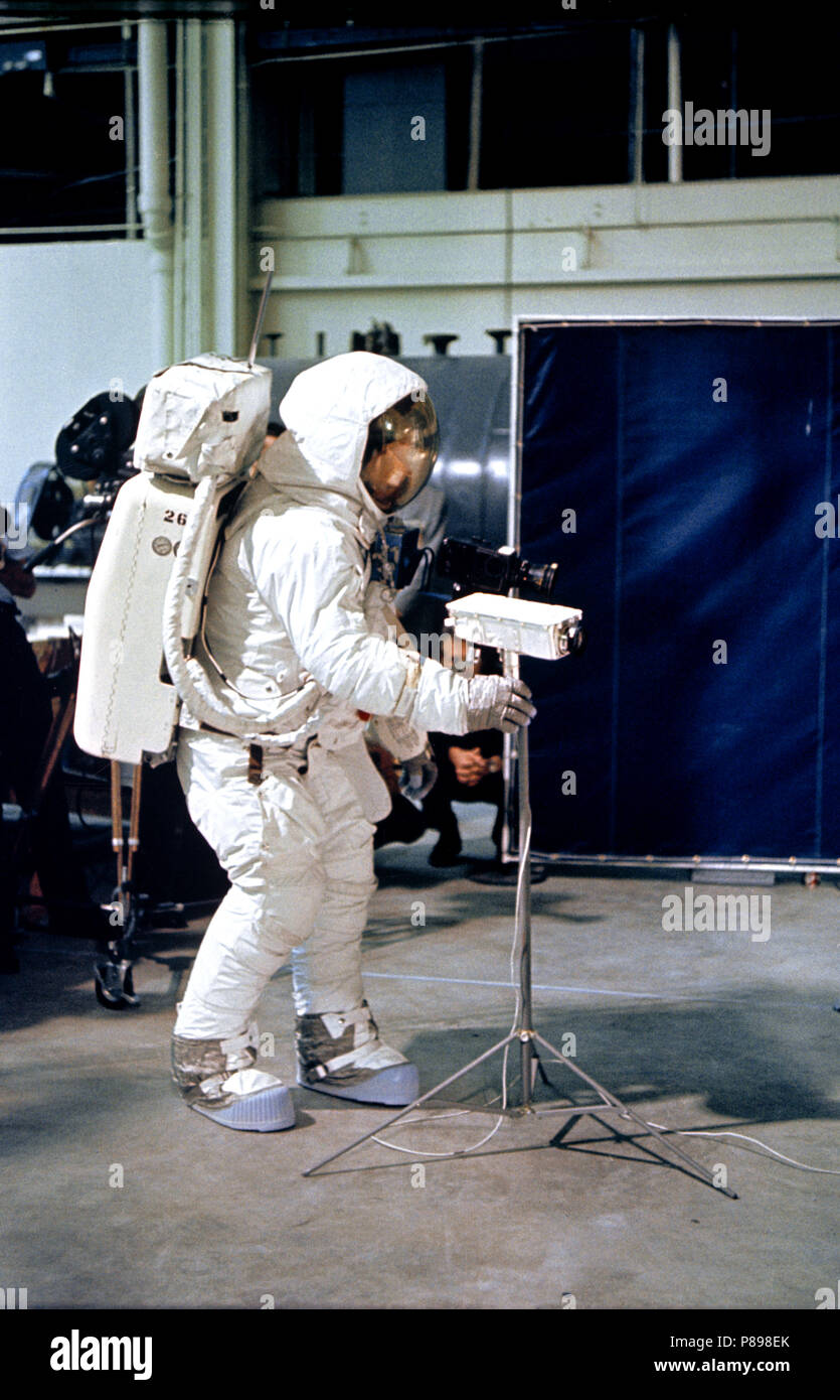 Astronaut Neil A. Armstrong, wearing an Extravehicular Mobility Unit (EMU), deploys a lunar surface television camera during lunar surface simulation training Stock Photo