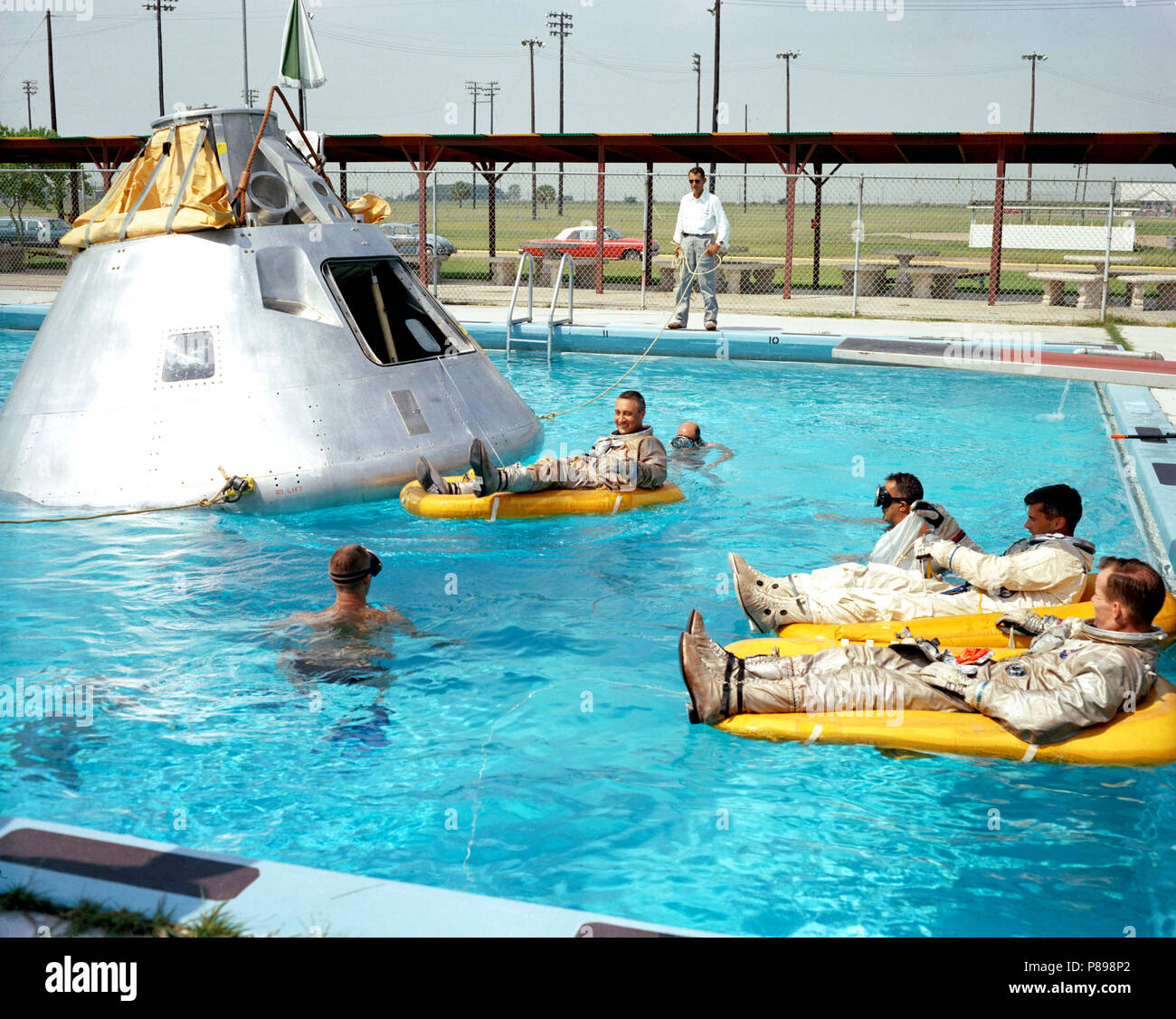 Prime crew for the first manned Apollo mission practice water egress procedures with full scale boilerplate model of their spacecraft Stock Photo