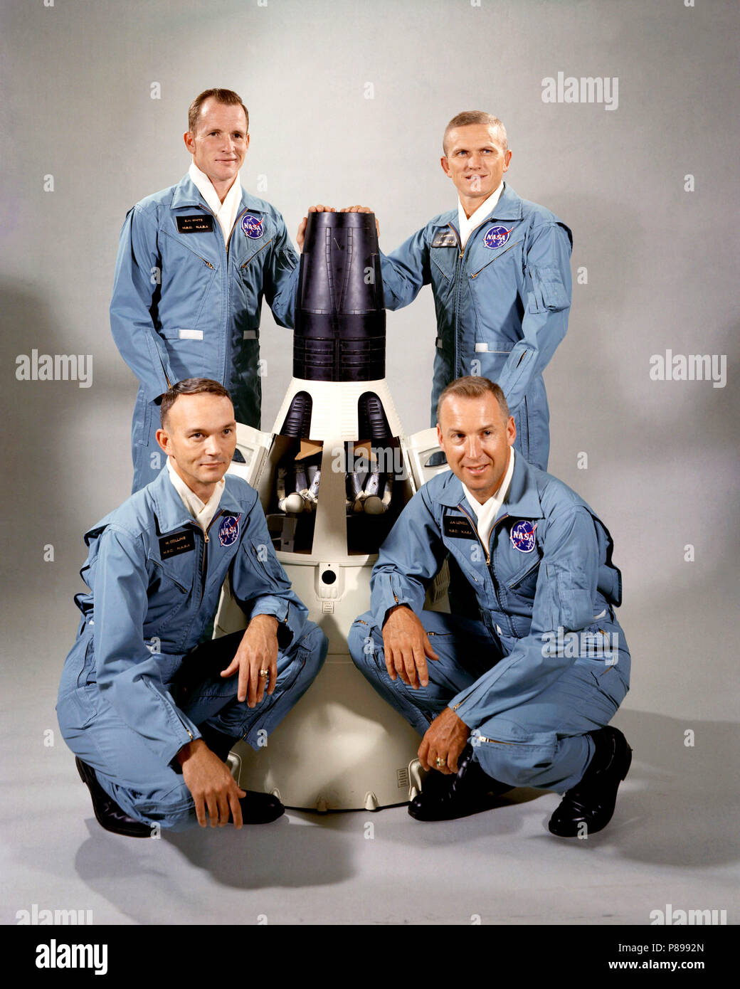 Portrait of the Gemini-7 prime and backup crew members around a model of the Gemini-7 spacecraft. From top right clockwise, Borman, Lovell, Michael Collins, Edward White Stock Photo