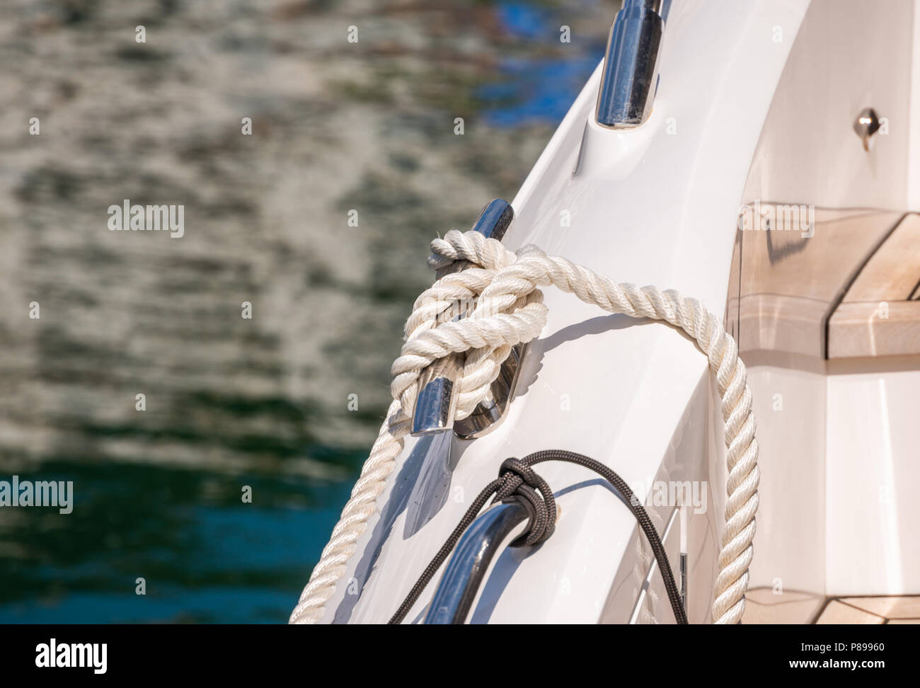 dock cleat on the side of a boat in a small marina, an element of