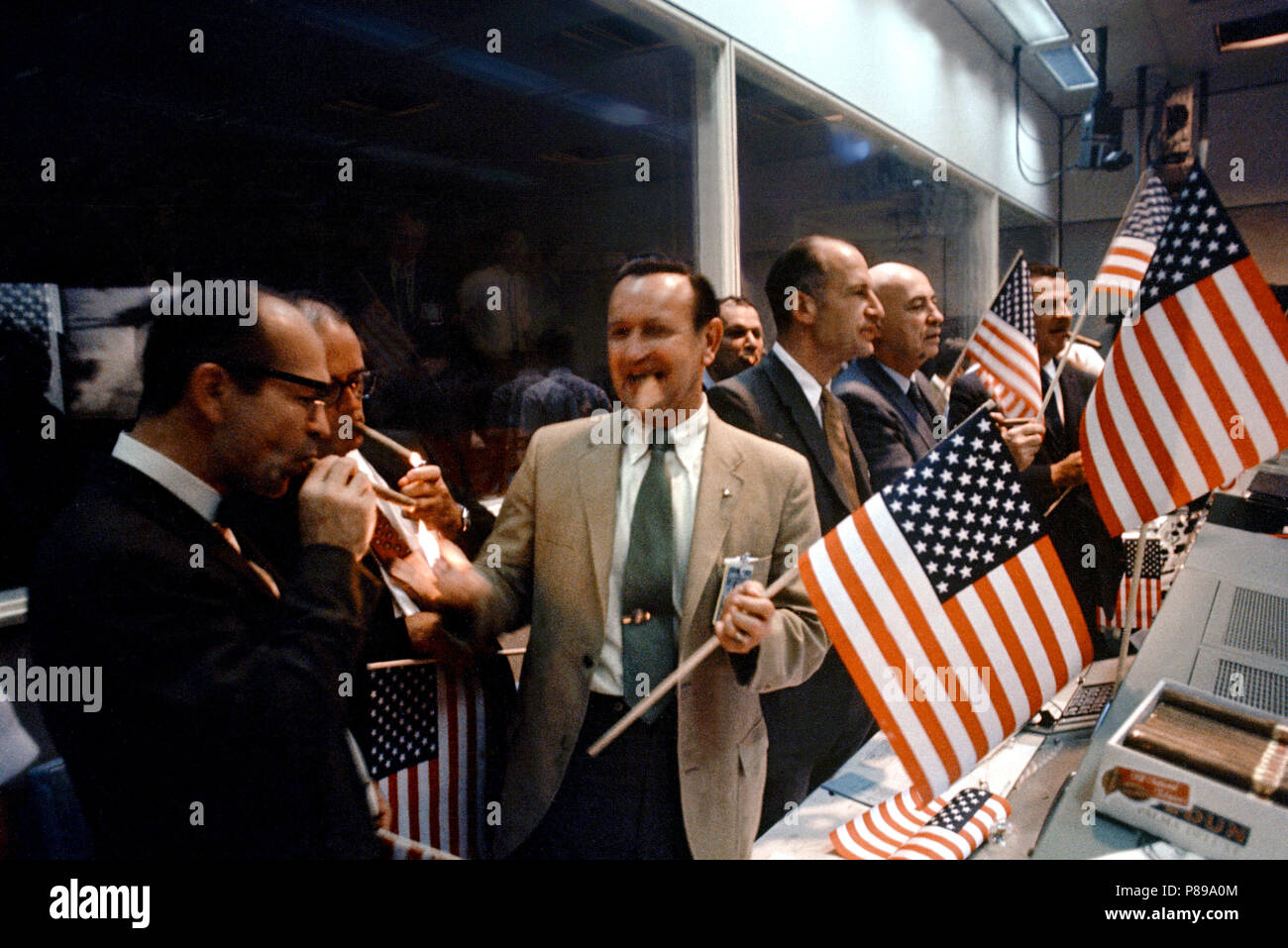 NASA and Manned Spacecraft Center officials join w flight controllers in the Mission Operations Control Room in celebrating the successful conclusion of the Apollo 11 lunar landing mission. Stock Photo