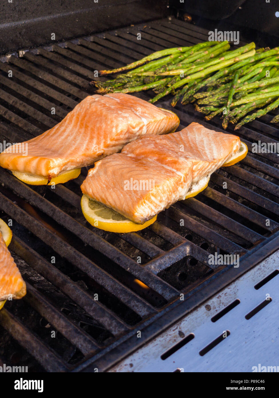 Step by step. Grilling salmon with lemons on outdooor gas grill Stock Photo  - Alamy