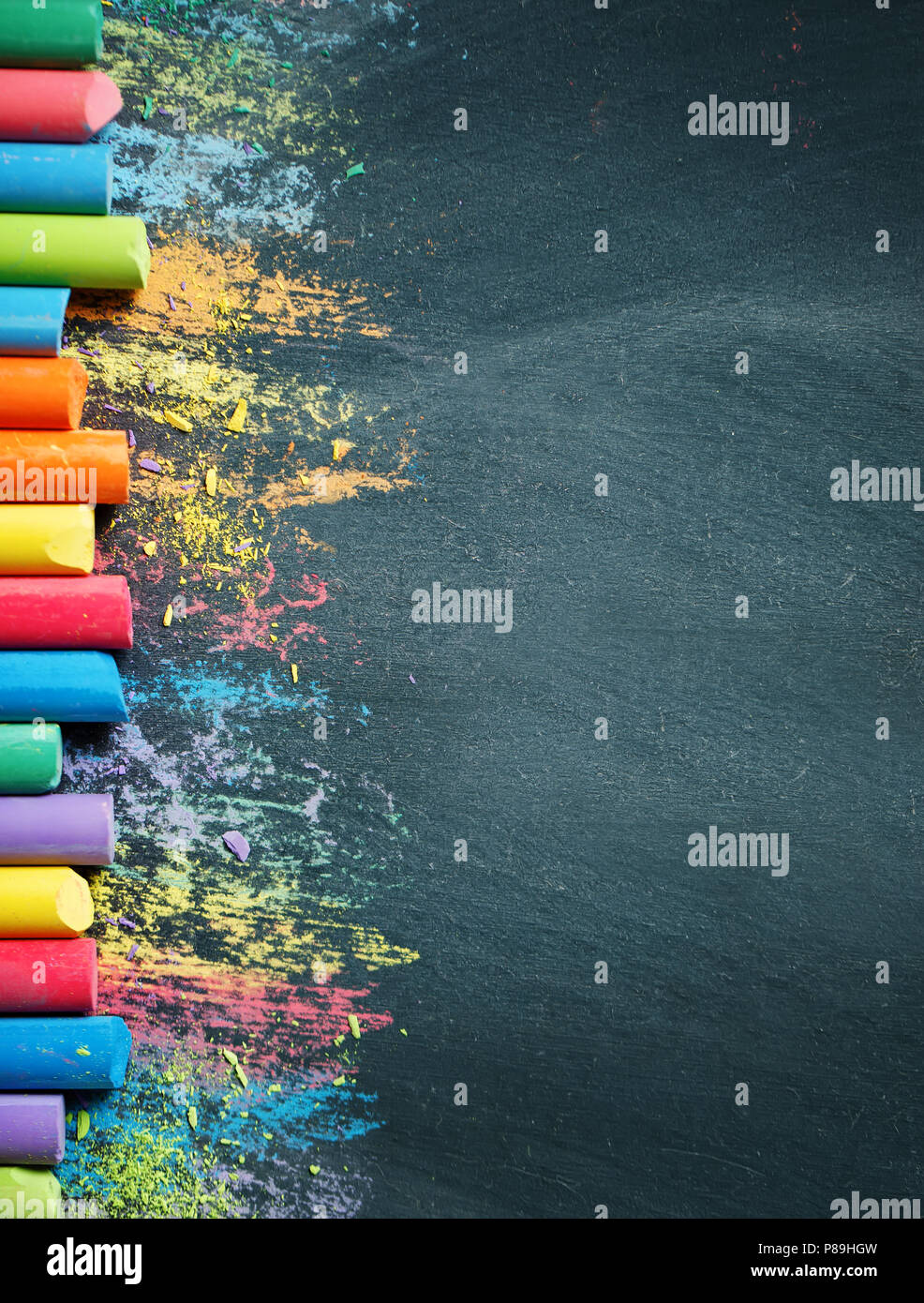 Colorful crayons on the blackboard, drawing. Back to school background. Stock Photo