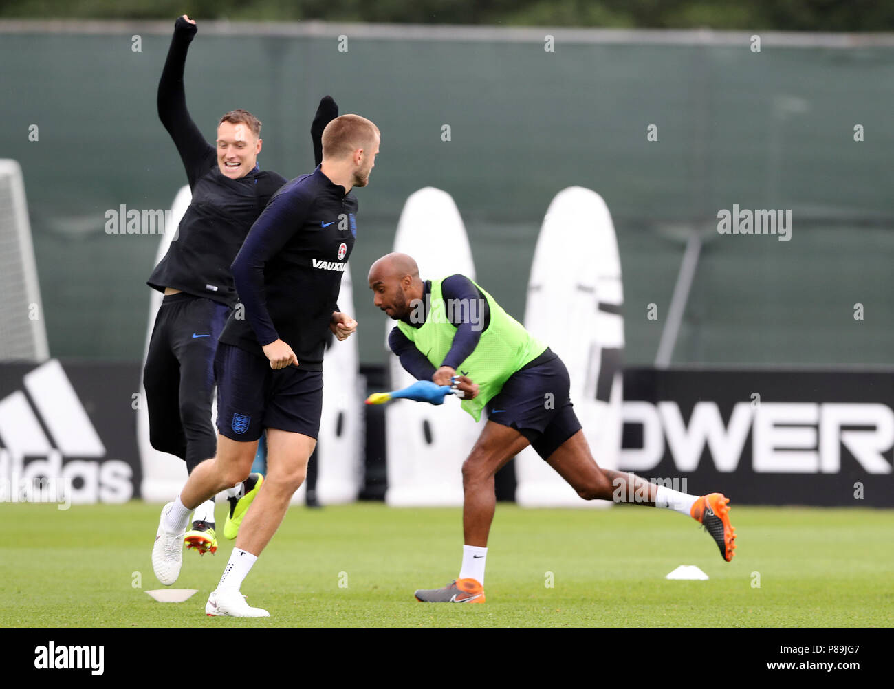 England's (from left to right) Phil Jones, Eric Dier and Fabian Delph play with a rubber chicken during the training session at the Spartak Zelenogorsk Stadium. Stock Photo