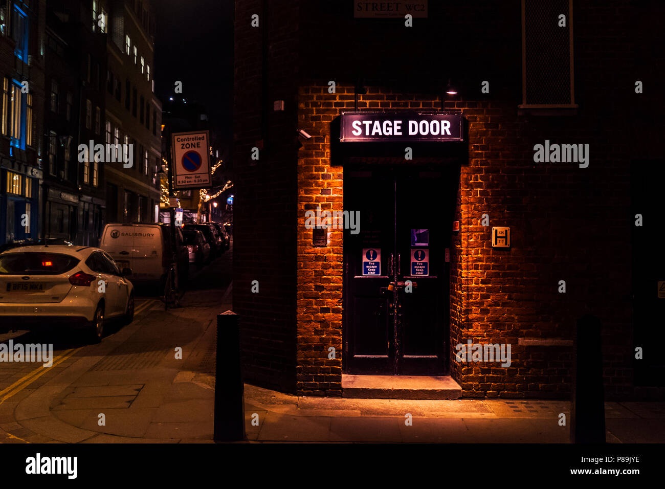 London, UK - March 15 2018: Stage door of the Cambridge theatre on Shelton Street, in Covent Garden. Night scene and neon colors LONDON, UK Stock Photo
