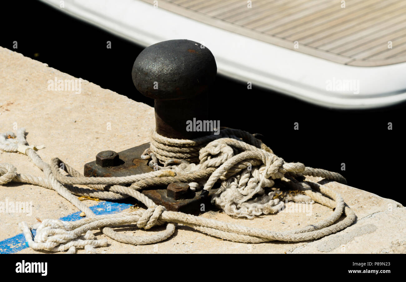 mooring post on the waterfront in a small marina, element for mooring