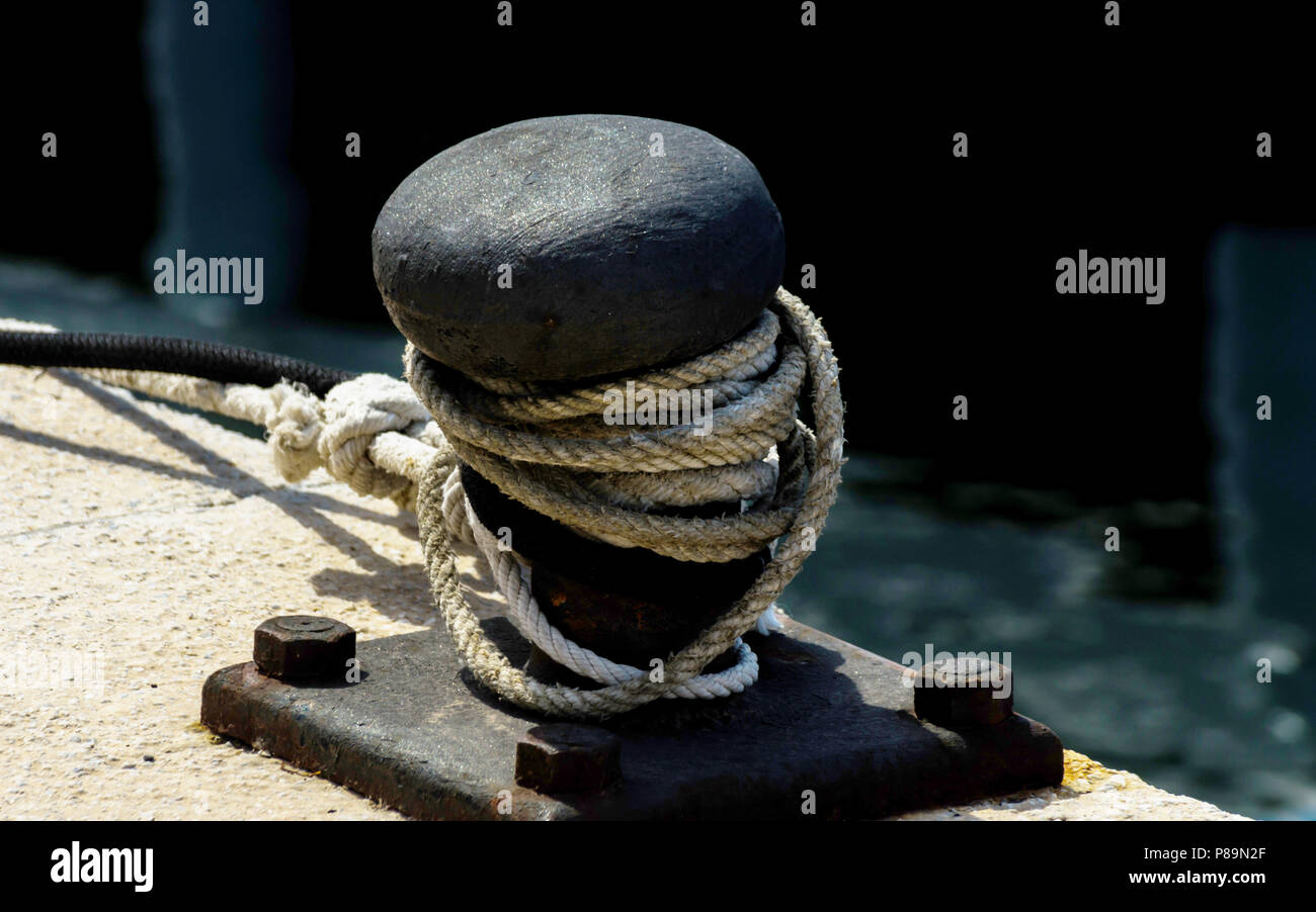 mooring post on the waterfront in a small marina, element for mooring