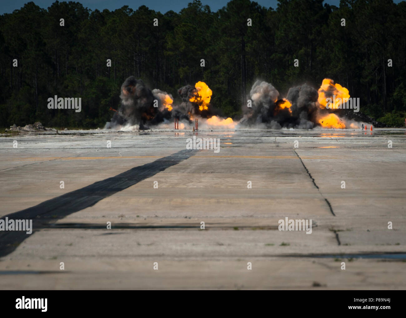 TYNDALL AIR FORCE BASE, Fla. (June 27, 2018) – Explosive Ordnance Disposal (EOD) Mobile Unit 12 technicians simulate battle damage to a runway during the annual airfield damage repair (ADR) experiment at Tyndall Air Force Base in Panama City, Florida.  Navy Expeditionary Combat Command conducted the experiment with Seabees, EOD personnel and government sponsored researchers to validate current ADR methods and test new technologies aimed at increasing ADR safety and efficiency.  (U.S. Navy Photo by Mass Communication Specialist 1st Class David Kolmel) Stock Photo